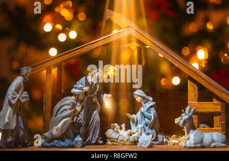 Christmas Manger scene with figurines including Jesus, Mary, Joseph, sheep and wise men. Focus on baby! Stock Photo