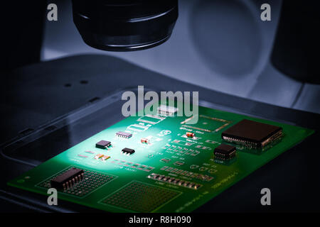 manufacture of chips on a printed circuit board under a microscope Stock Photo