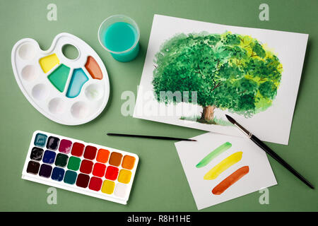 Painting tools in art studio on green background. School concept, creativity art concept, watercolor painting hobby concept. Stock Photo