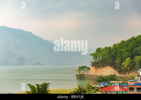 View of Phewa Lake shoreline  in Pokhara, Nepal in the foothills of the Himalayan Mountains Stock Photo