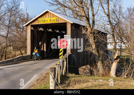 Lancaster, PA, USA - December 13, 2018:  Bitzer’s Mill Covered Bridge spans the Conestoga River in Lancaster County, PA. It is the oldest bridge in th Stock Photo