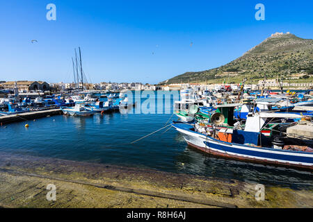 Traditional colorful fishing boats at Favignana harbor in a beautiful sunny day, Aegadian Islands, Sicily, Italy Stock Photo