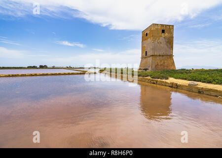 Salt evaporation pond and Nubia tower at salt flats near Trapani, Sicily, Italy Stock Photo