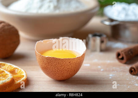 Fresh egg and other ingredients for Christmas baking Stock Photo