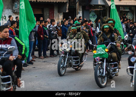 Khan Yunis, Gaza Strip, Palestinian Territories. December 15, 2018 - The Al-Qassam brigades, the military wing of Hamas, hold a military parade on the occasion of the 31th anniversary of the creation of the Palestinian resistance movement of Hamas, on 15th December 2018 in Khan YYunis, in the southern Gaza Strip. The Islamist movement has controlled the Gaza Strip since 2007, after winning Palestinian legislative elections, and since then Israel has imposed a strict air, land, and sea blockade on the Gaza strip justifying it with security reasons. Credit: ZUMA Press, Inc./Alamy Live News Stock Photo