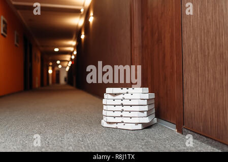 Carton pizza boxes left at the door. Pizza delivery business concept, fast delivering service, nobody Stock Photo