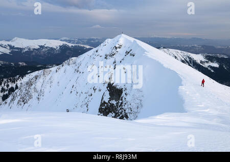 Extreme tourist walks along the ridge. Winter landscape in mountains Stock Photo