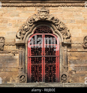 A red iron door  in Durbar Square, a Unesco World Heritage Site in Kathmandu, Nepal Stock Photo