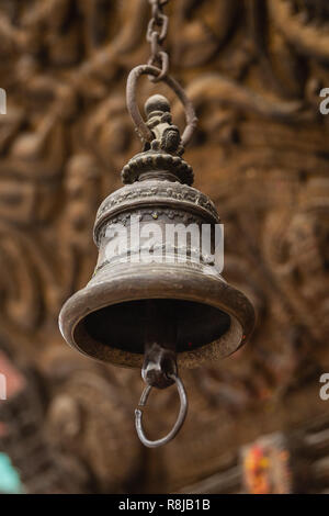 Brass gold bell hanging at a temple in Kathmandu, Nepal Stock Photo