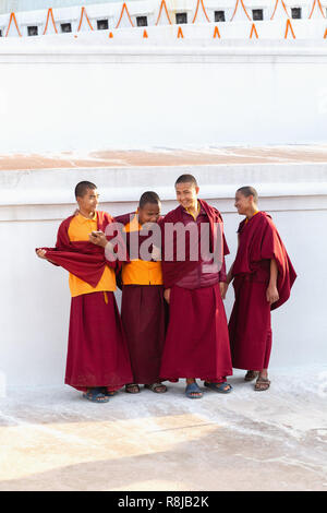 Group of young laughing Buddist Monks at the Boudhanath Stupa in Kathmandu, Nepal Stock Photo
