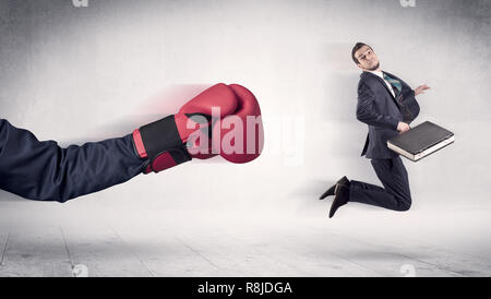 Huge Boxing Gloves punches innocent businessman concept  Stock Photo