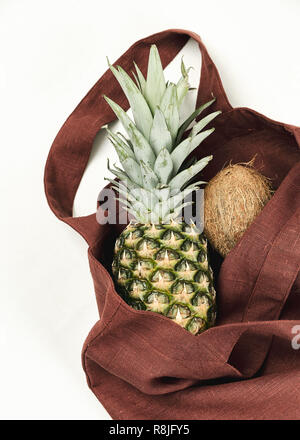 Brown Reusable Zero Waste Bag with Pineapple. Natural Environment Friendly Linen or Cotton Basket for Local Tropical Fruit Shopping Stock Photo