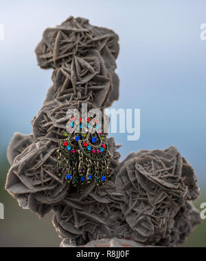 targui earrings exposed on a desert rose in algeria, beautifull background Stock Photo