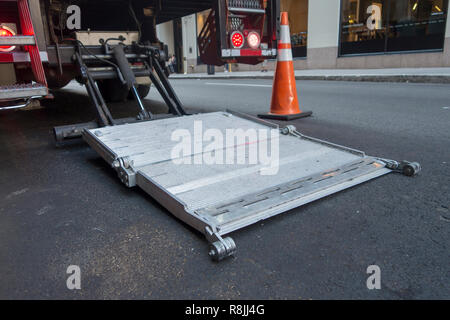delvering truck stainless steel loading and unloading gate hydronic lift urban city street Stock Photo
