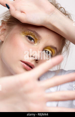 Girl covers herself from the camera with her hands Stock Photo