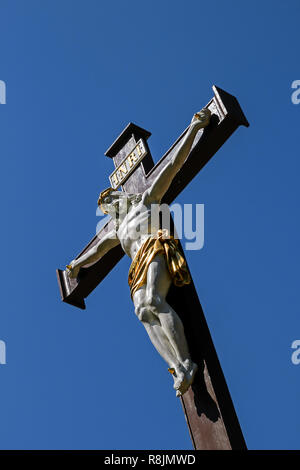 christian cross in front of a bright blue sky Stock Photo