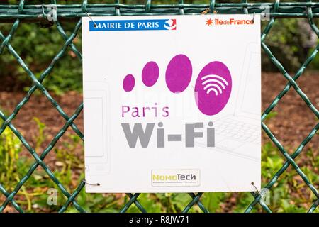 France, Paris, Montsouris Park, young woman using public wifi Stock Photo