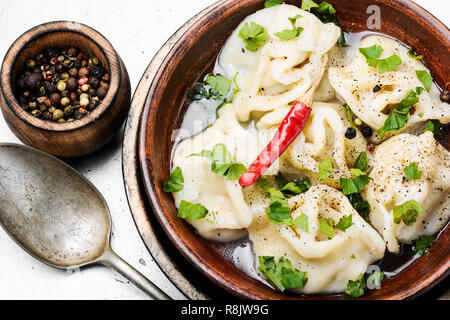Traditional Russian dish pelmeni.Meat dumplings on rustic background Stock Photo
