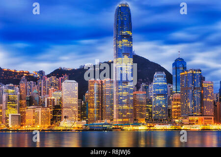 Central part of Hong Kong city CBD skyline around the tallest tower of finance centre surrounded by smaller modern urban office skyscrapers at sunrise Stock Photo