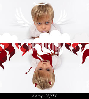 Naughty or good child for Christmas card? PF or letter to Santa-Claus for Christmas. Little child boy appearing as an adorable angelic devil Stock Photo