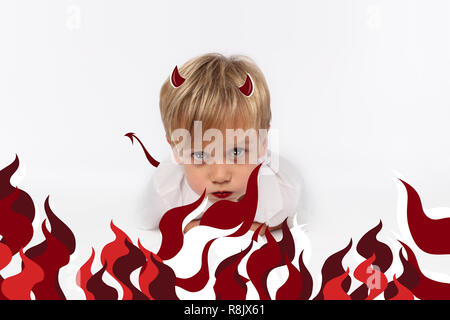 Naughty or good child for Christmas card? PF or letter to Santa-Claus for Christmas. Little child boy appearing as an adorable angelic devil Stock Photo