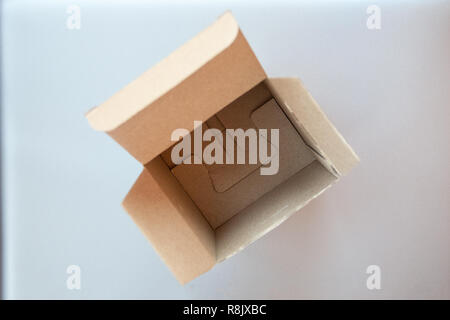 Opened big square cardboard craft gift box on the silver gray metal background Stock Photo