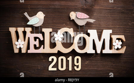 message 'welcome 2019' on rustic wooden background Stock Photo