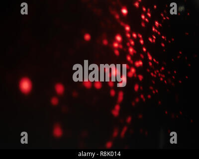 abstract lens flare on background. Red defocused bokeh lights. blur christmas wallpaper decor. festive glowing circles design. Stock Photo