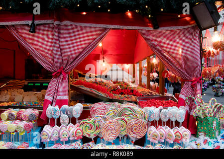 Christmas market stand with candies and lollipops,  on city street Stock Photo
