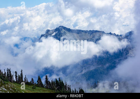 large mountains covered in dense cloud and fog Stock Photo