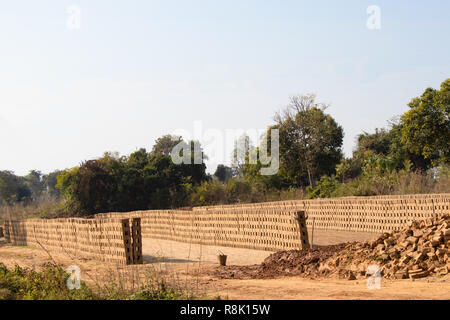 Row soil mud bricks place in open to drying. Stock Photo