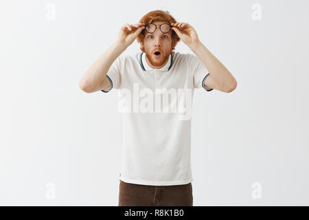 Portrait of amused and impressed curious attractive woman in t-shirt ...