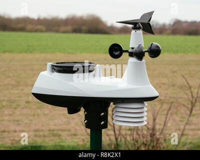 Personal weather station with multiple sensors with agricultural landscape in the background. Stock Photo