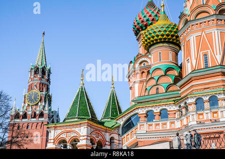 A detail of the colored steeples ot Saint Basil's Cathedral in Moscow, Russia. The clock tower of the Kremlin appears in the background Stock Photo