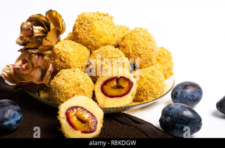 Bread crumb dumplings with plums on a plate isolated Stock Photo