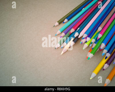 Colour pencils isolated on brown wooden clean background. Close up. Stock Photo