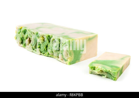 Handmade green and white artisan noni soap loaf and soap bar on white background Stock Photo