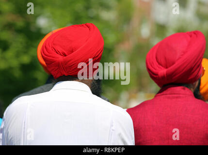 two indian men with red turbants outdoors