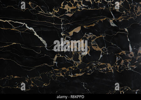 Elite and expensive black polished marble with yellow veins Nero Portoro. Stock Photo