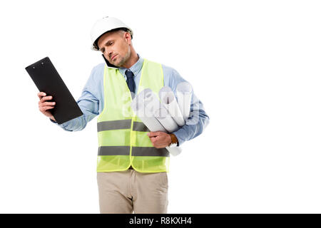 handsome engineer holding blueprints, talking on smartphone and looking at clipboard isolated on white Stock Photo