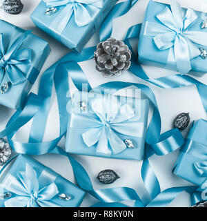 Christmas boxes with gifts blue color on white background cones nuts decor. Top view flat lay square Selective focus. Square Stock Photo
