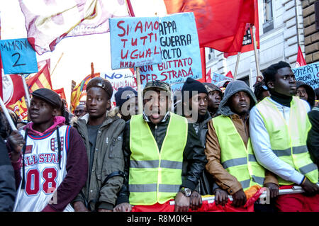 Rome, Italy. 15th Dec, 2018. 'Get Up Stand Up for Your Rights'. This is the name of the demonstration launched in Rome by the Usb base syndicate, which saw thousands of migrant agricultural workers and large-scale distribution workers, students, unemployed, precarious, ask for residence permits for all, social justice, rights and dignity against anti-social policies, racism and the Salvini decree. Many protesters wore yellow vests, inspired by protests in France. Credit: Patrizia Cortellessa/Pacific Press/Alamy Live News Stock Photo