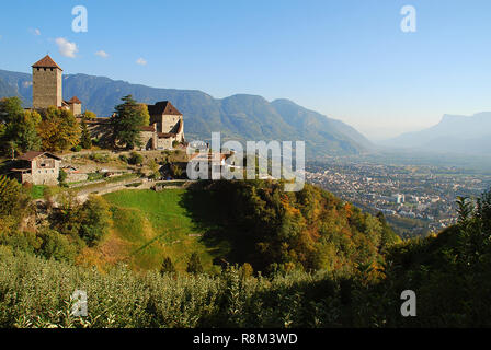 Tyrol Castle in Tirolo, South Tyrol, Italy and a view in the vally with meran. Tyrol Castle is home to the South Tyrolean Museum of Culture and Provin Stock Photo