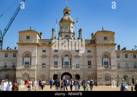 Tourists walk towards the arch of Horse Guards Parade under a winter's blue sky, Whitehall, London, England, United Kingdom Stock Photo