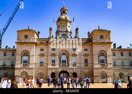 Tourists walk towards the arch of Horse Guards Parade under a winter's blue sky, Whitehall, London, England, United Kingdom Stock Photo