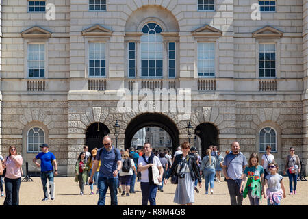 Tourists walk towards the arch of Horse Guards Parade under a winter's blue sky, Whitehall, London, England, United Kingdom Stock Photo