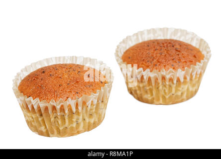 Two homemade cupcakes with poppy seeds isolated on white. Shallow focus. Stock Photo
