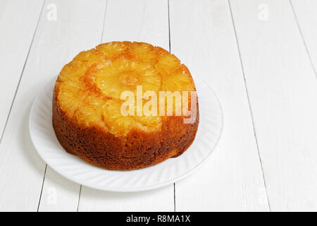 Homemade Pineapple Upside Down Cake on white wooden table. Shallow focus. Stock Photo