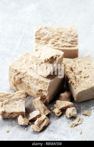 Dry yeast crumbled and yeast block for baking. Stock Photo