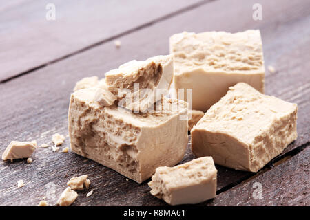 Dry yeast crumbled and yeast block for baking. Stock Photo